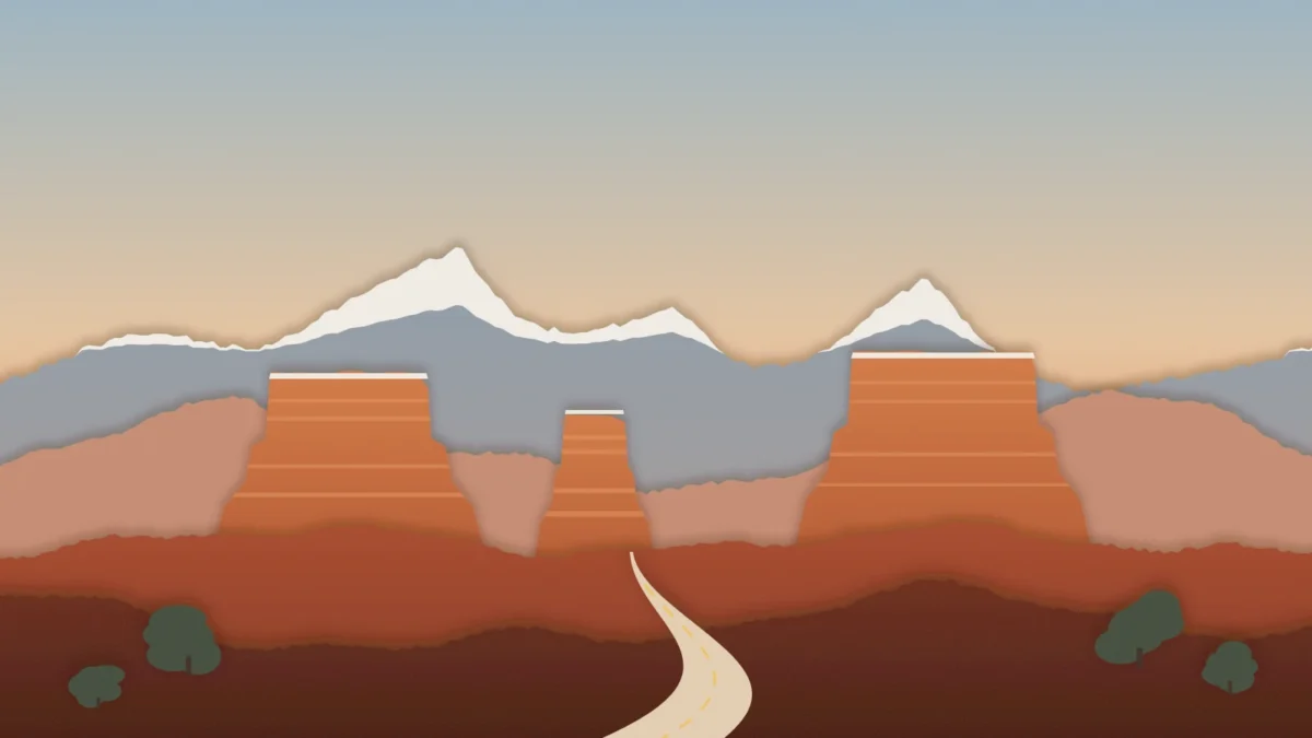 best national parks to visit in november featured | Two Scots Abroad Paper-cut illustration of red rock buttes in front of snow-capped mountains at golden hour, with a road winding in, for the best national parks to visit in November