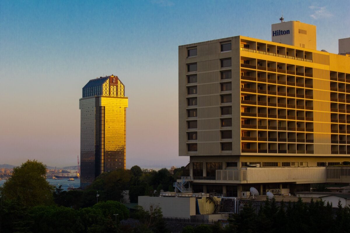 Capture of İstanbul's skyline with gleaming modern buildings at sunset.