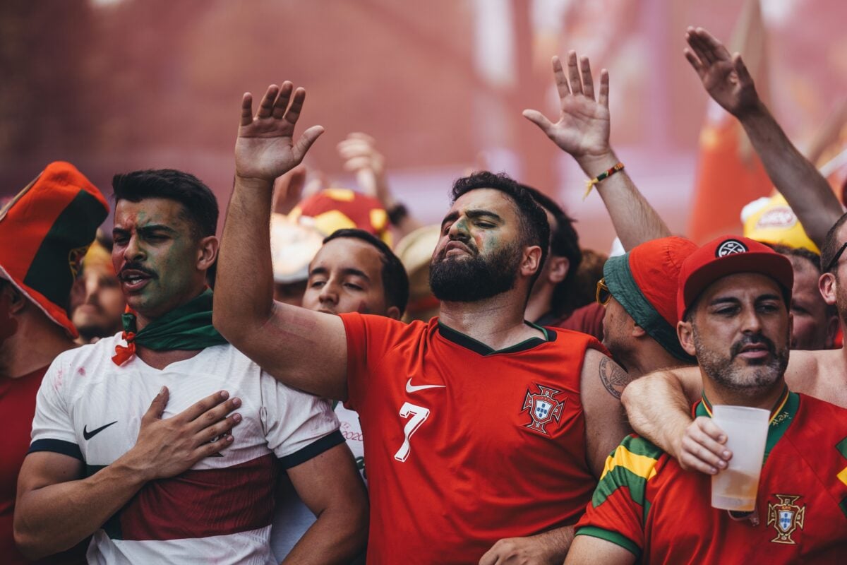 pexels 27271702 | Two Scots Abroad Excited group of soccer fans passionately cheering at a game, showing their vibrant team spirit.