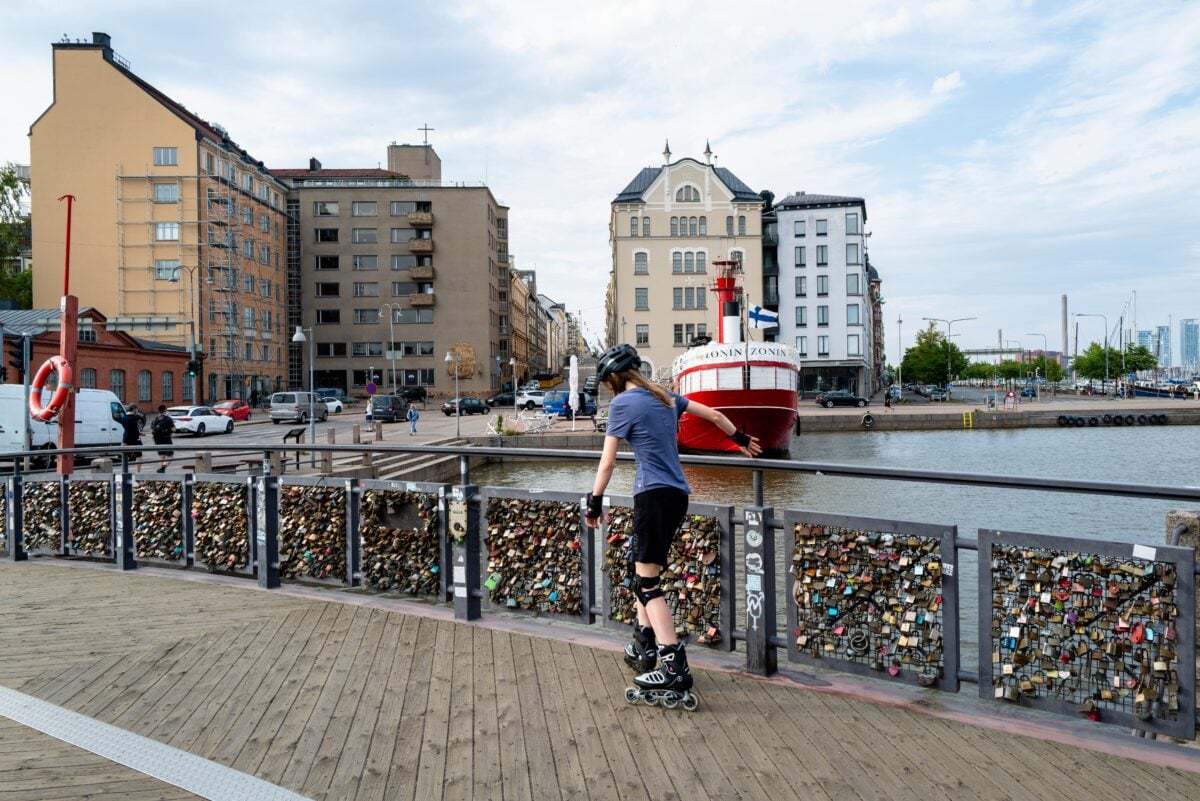 pexels 32978290 | Two Scots Abroad Young skater rollerblading on a bridge with love locks in Helsinki, Finland.