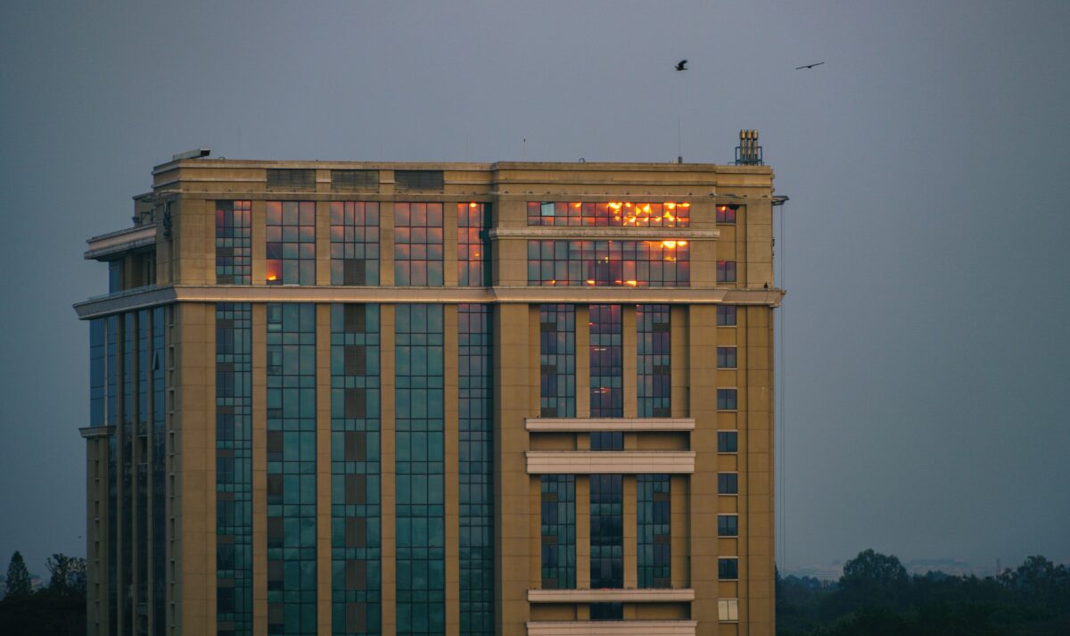 A modern high-rise building with sunset reflections in Bengaluru, Karnataka, India.