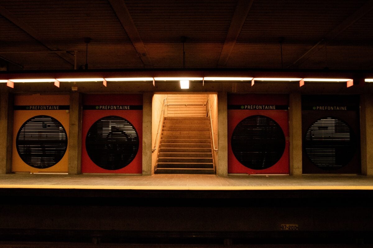 View of the Prefontaine Metro station staircase with vibrant colored doors in Montréal.