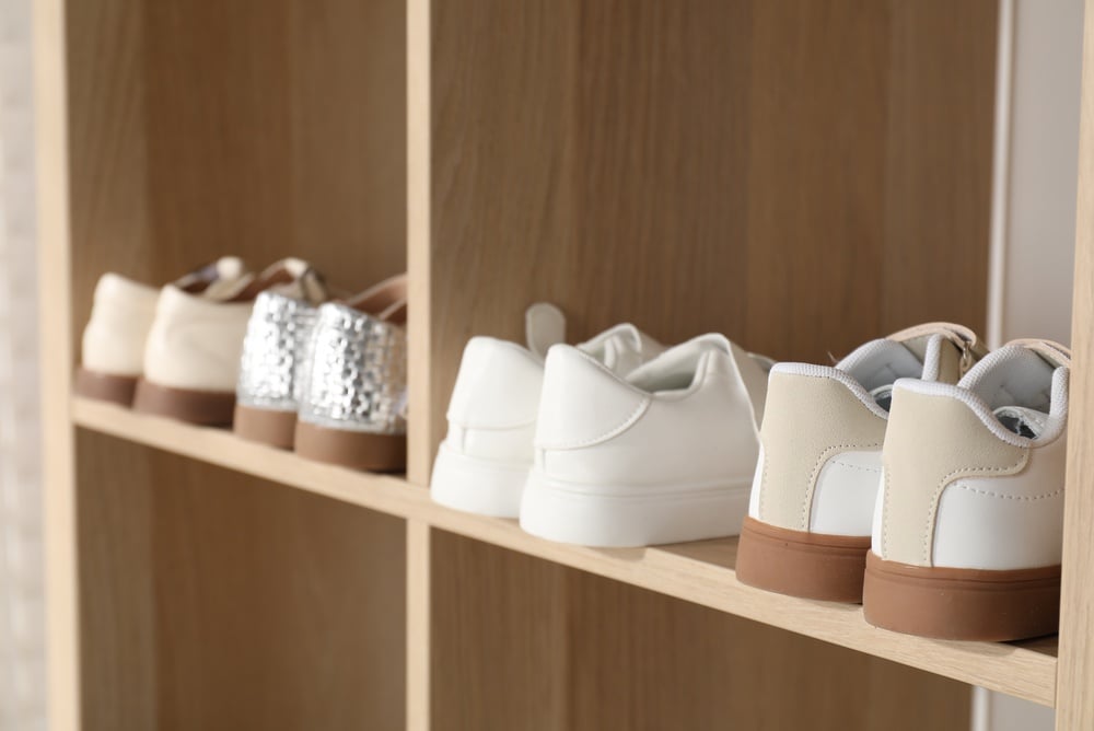 2739116425

Different stylish children's shoes on shelving unit indoors, closeup