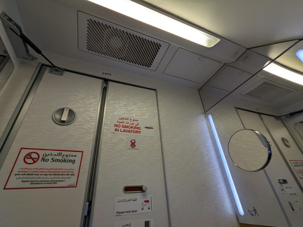 bathroomd oor airplane shutterstock 2443160965 | The Dirtiest and Cleanest Parts of an Airplane: What Travelers Should Know
