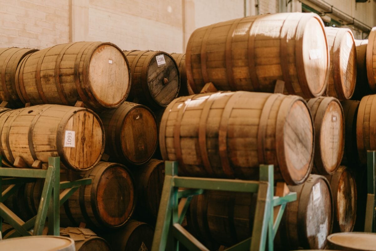 pexels 10039992 | Two Scots Abroad Stacked wooden barrels aging tequila in a Mexican distillery.