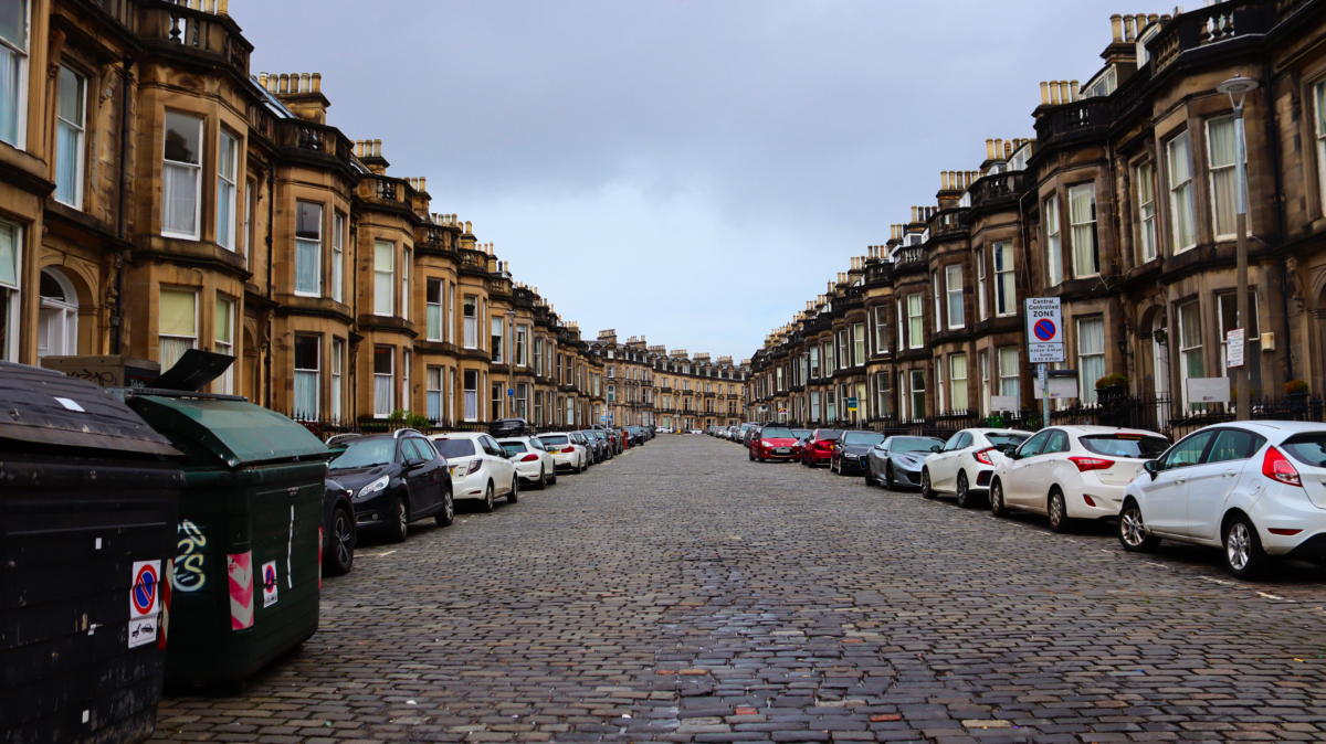 pexels 11304700 | Two Scots Abroad Classic Edinburgh street lined with Victorian architecture and parked cars, showcasing urban elegance.