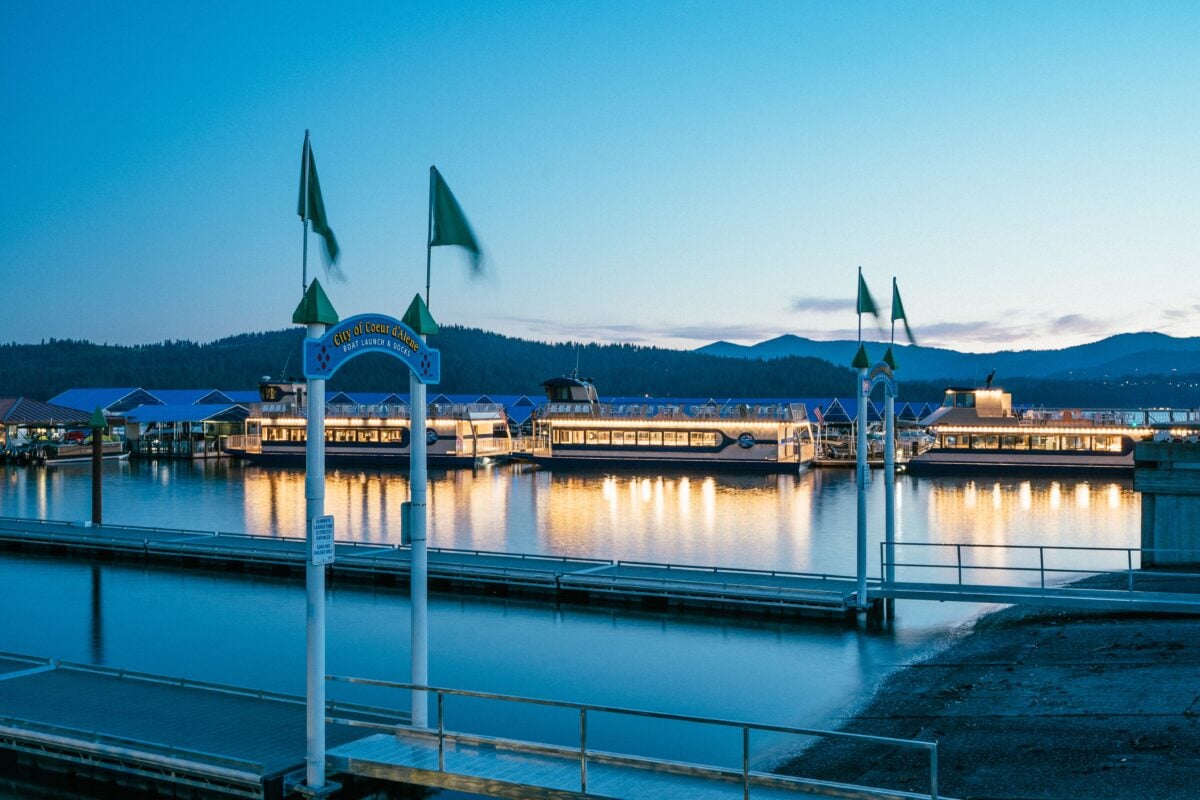 Illuminated marina and dock with reflections at sunset in Coeur d'Alene, Idaho.