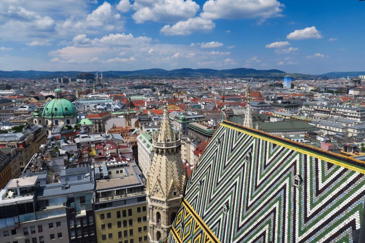 pexels 19542667 | Two Scots Abroad Stunning aerial perspective of Vienna cityscape with St. Stephen's Cathedral, vibrant rooftops, and clear skies.