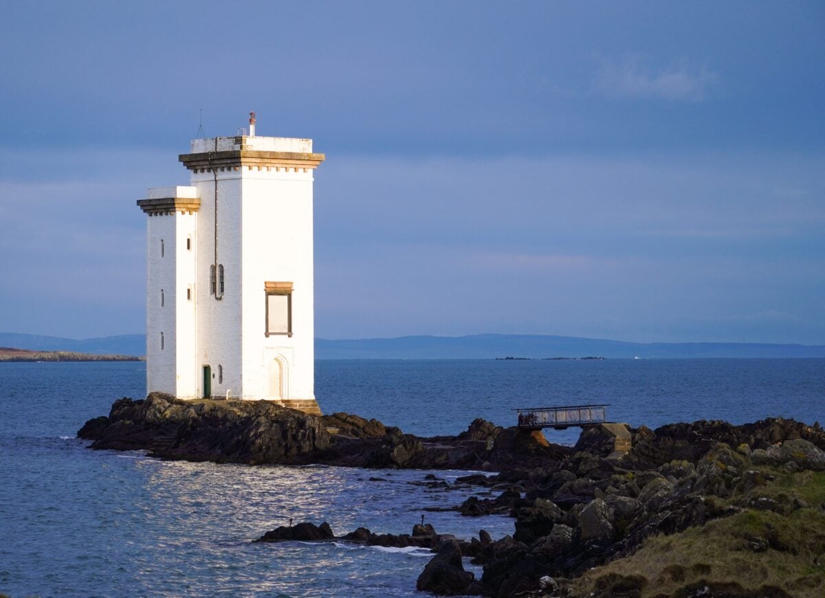 View of the Carraig Fhada Lighthouse on Islay, Scotland by the seashore.