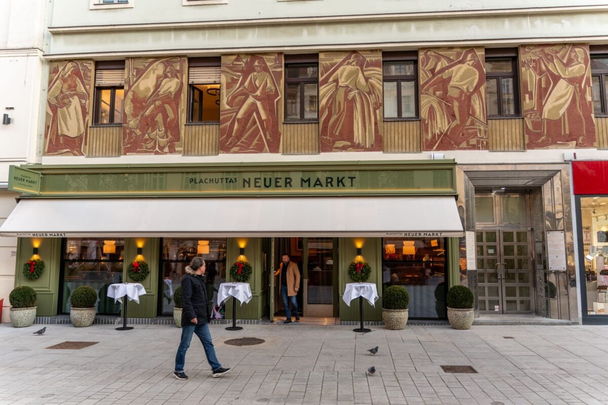 Exterior of Plachutta's Neuer Markt restaurant in Vienna with decorative facade and passersby.