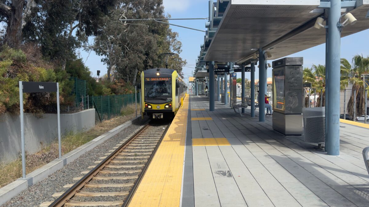 pexels 31911759 | Two Scots Abroad Santa Monica-bound train arriving at Palms Station under a clear sky.