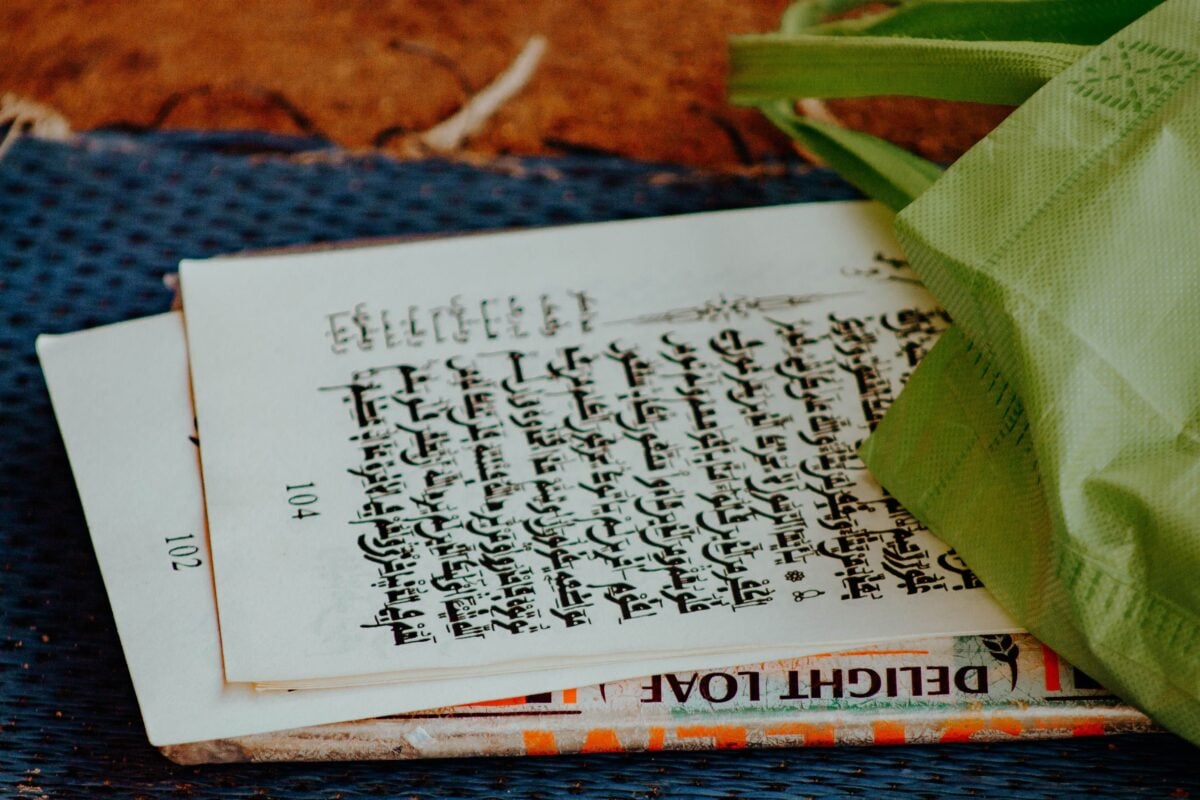 pexels 33858009 | Two Scots Abroad A detailed view of an old manuscript with a green bag, emphasizing vintage charm.