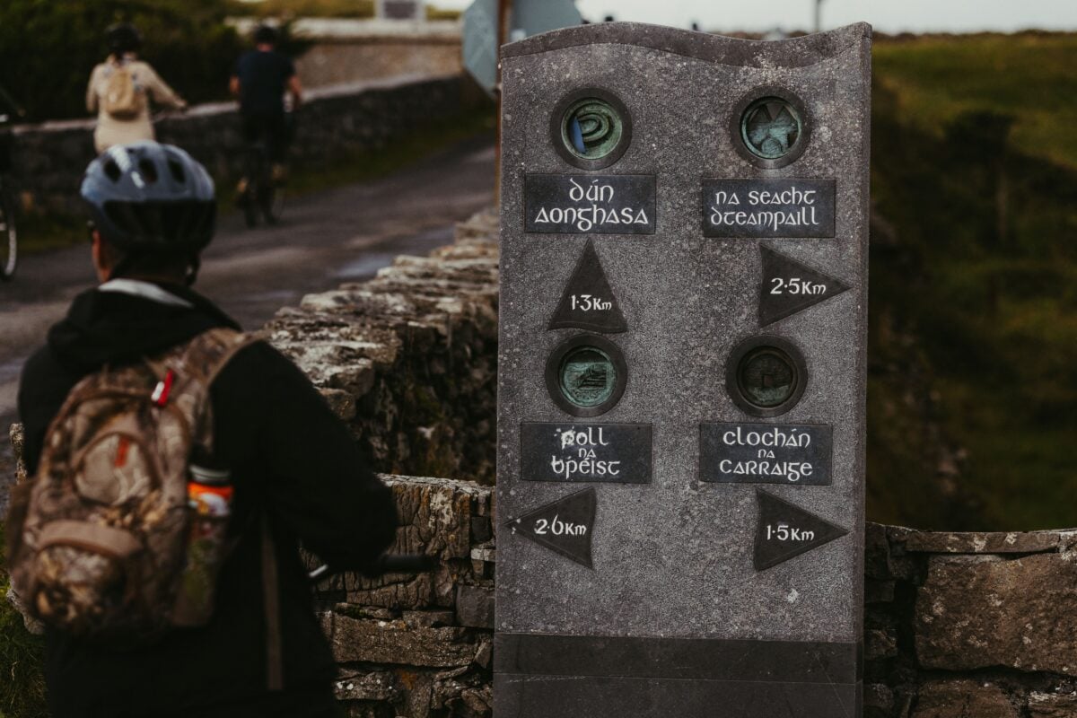 pexels 33880801 | Two Scots Abroad A rustic signpost on a path in Inishmore, Ireland, showing distances to local landmarks.
