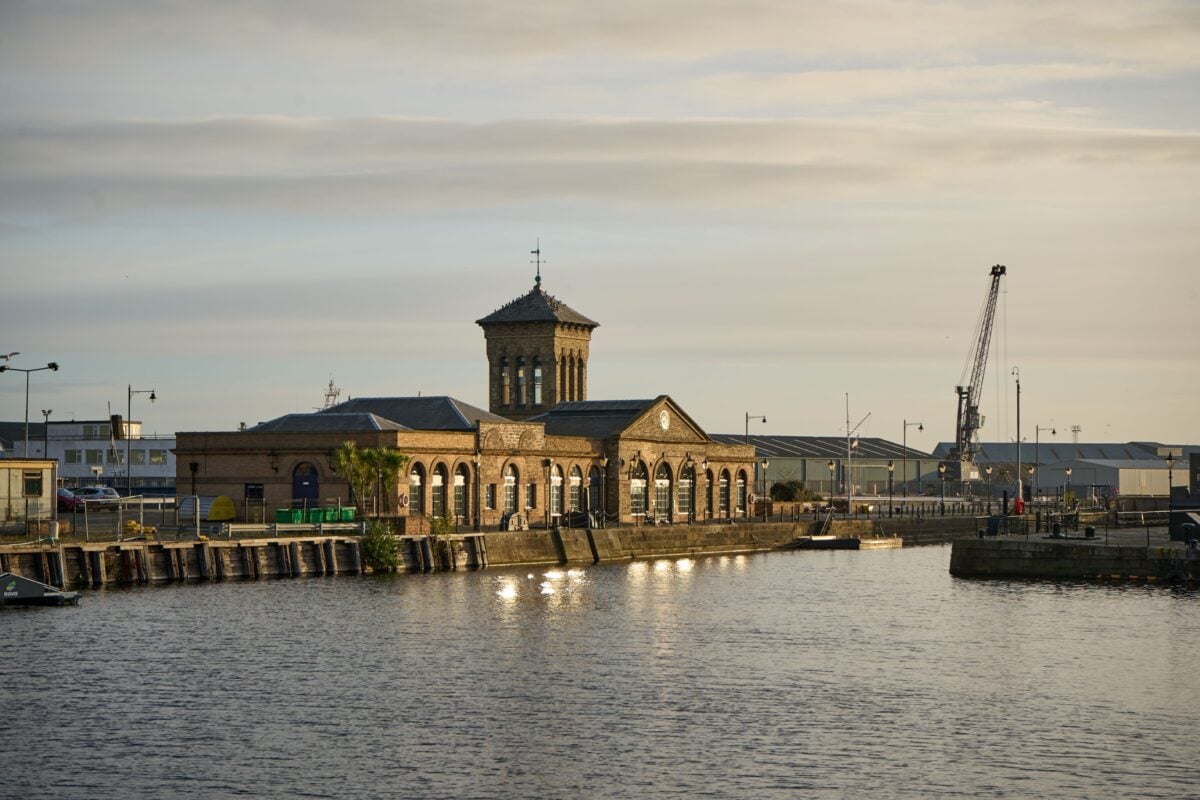 pexels 34693857 | Two Scots Abroad Peaceful view of historic Leith Harbour with reflections and crane at sunset.