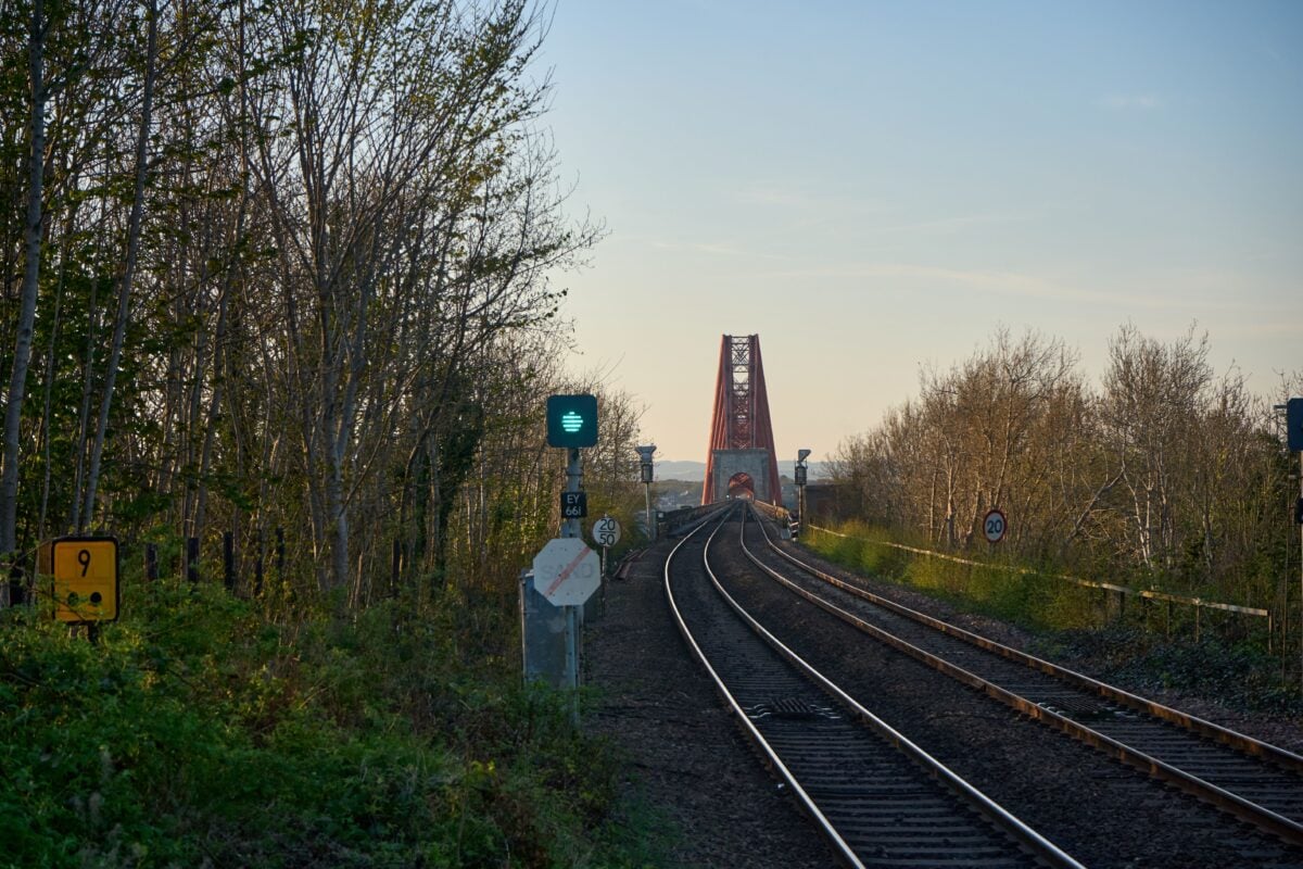 pexels 35210620 | Two Scots Abroad Captivating view of Forth Rail Bridge with railway tracks at sunset in Scotland.