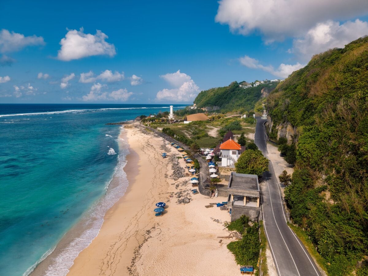 pexels 36299199 | Two Scots Abroad Aerial view of a Bali beach with a lighthouse and scenic coastline in Indonesia.