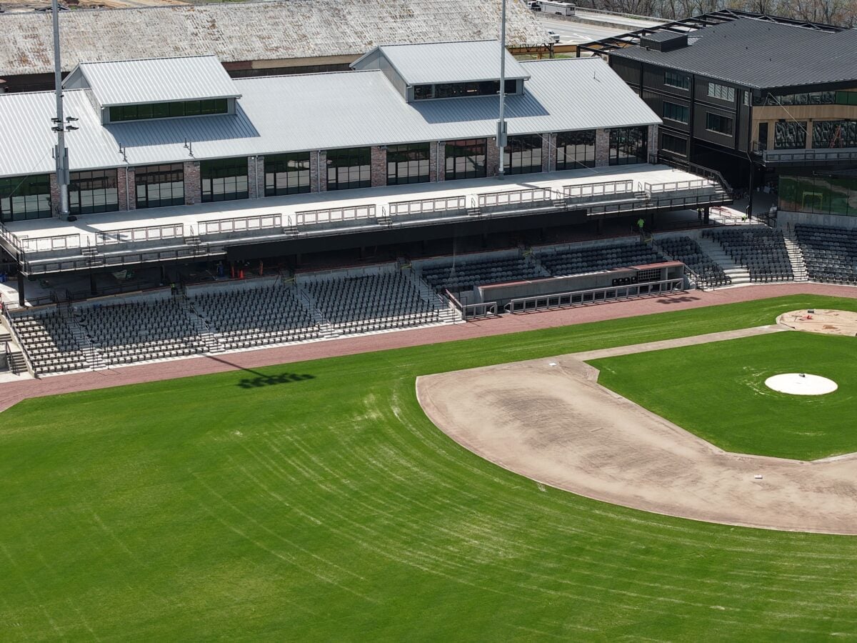 An empty baseball stadium with green field and stands, captured from above in Chattanooga, Tennessee.
