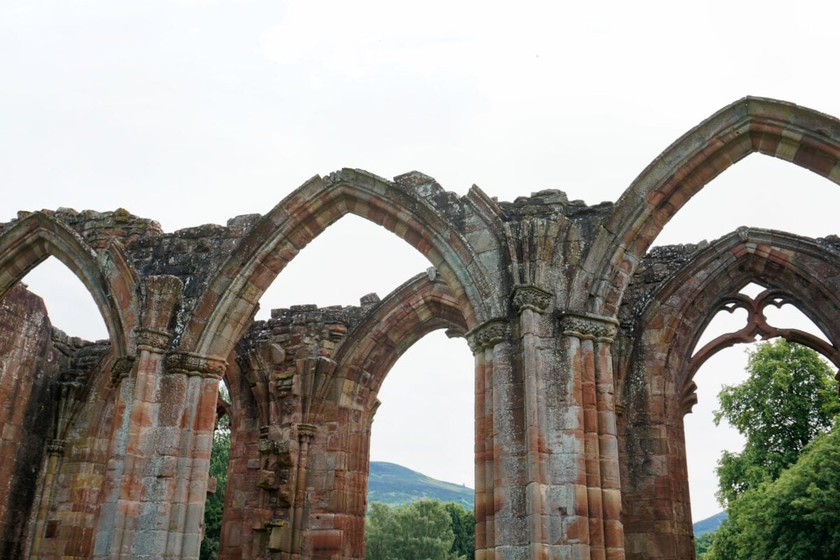 pexels 36655641 | Two Scots Abroad Historic medieval arches at Melrose Abbey in Scotland, showing ancient architectural ruins.