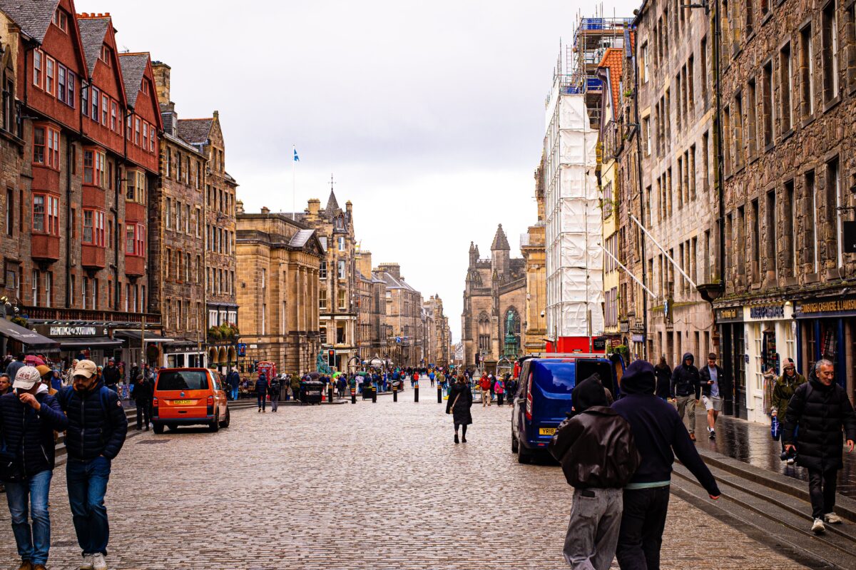 pexels 37091110 | Two Scots Abroad Cobblestone street in Edinburgh bustling with people and surrounded by historic architecture.
