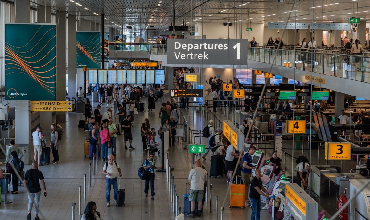 pexels 37772239 | Two Scots Abroad Crowds in the departure area of Amsterdam's Schiphol Airport, showcasing bustling travel activity.