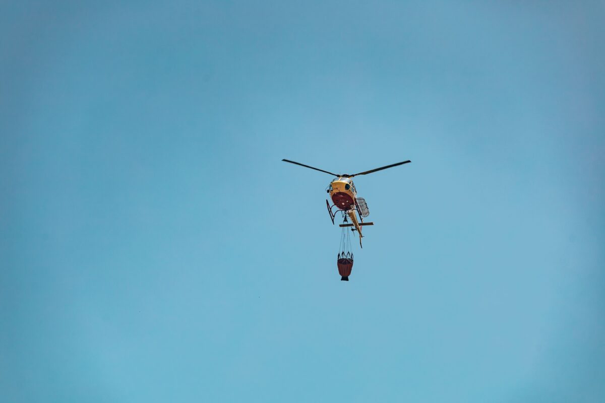 Helicopter with water bucket fighting a fire in Braga, Portugal.