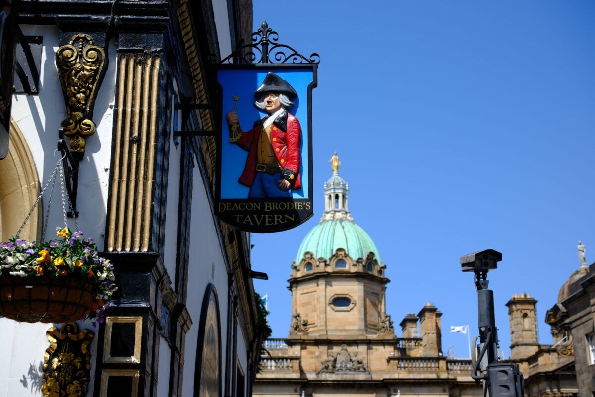 pexels 37889516 | Two Scots Abroad Deacon Brodie's Tavern sign with a historic building in Edinburgh, Scotland.