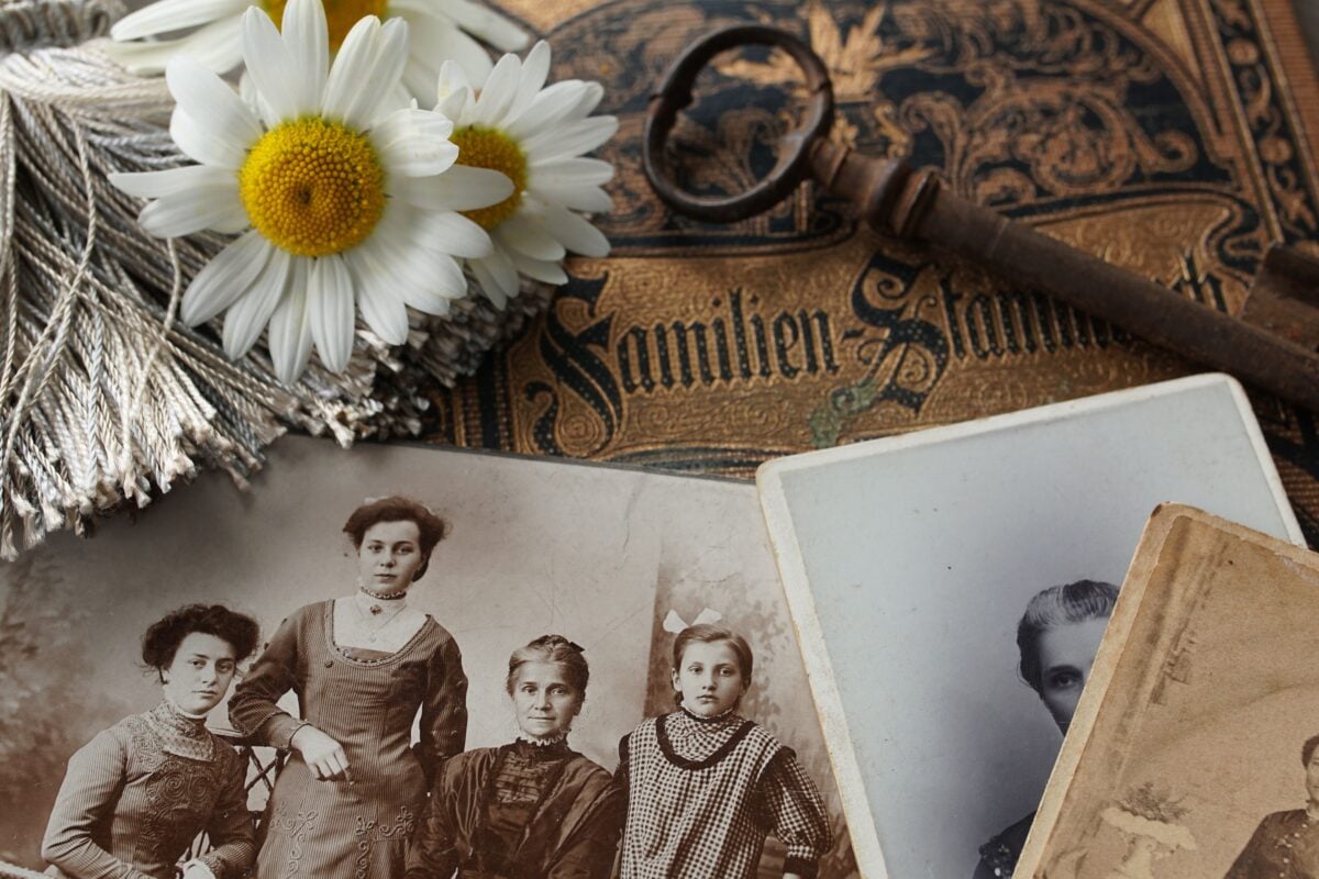 pexels 4394514 | Two Scots Abroad Vintage family photographs with daisies and an antique key evoke memories and nostalgia.