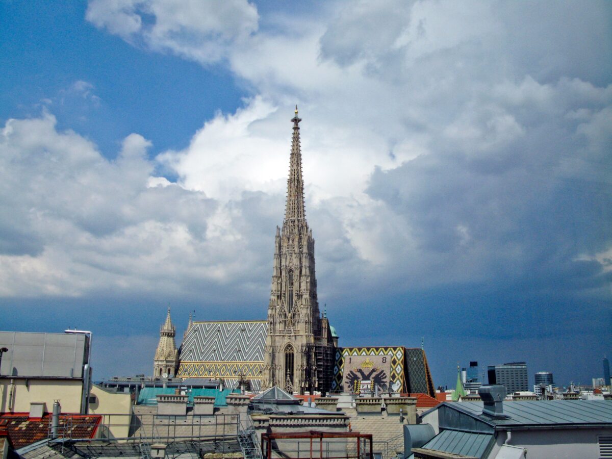 pexels 5229431 | Two Scots Abroad St. Stephen's Cathedral against a vibrant Vienna skyline under dramatic clouds.