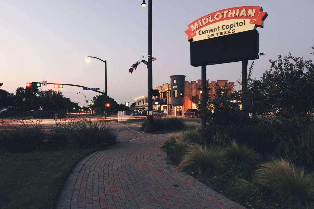Downtown Midlothian, Texas at dusk showcasing signage and urban architecture.