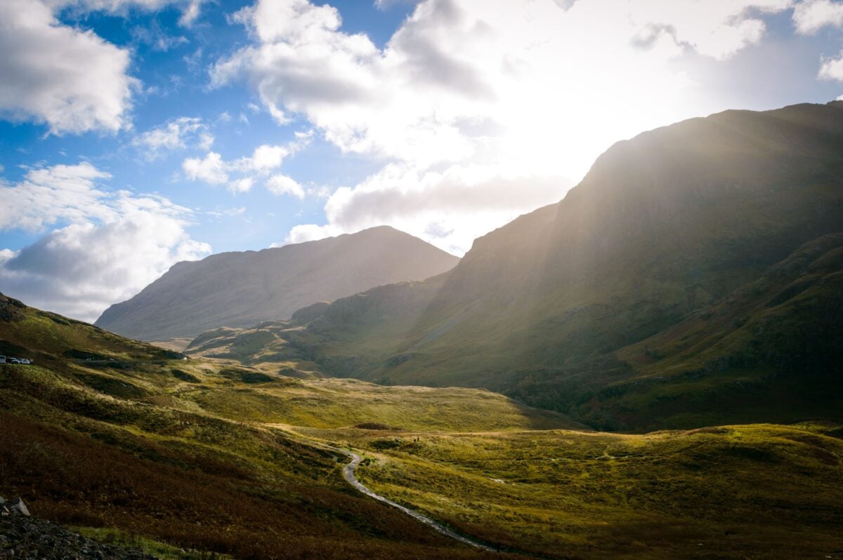 pexels 5568718 | Two Scots Abroad Dramatic view of the Scottish Highlands with sunbeams over lush green valleys and majestic mountains.