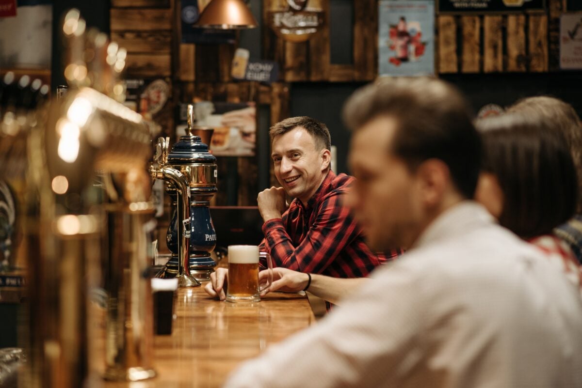pexels 5858062 | Two Scots Abroad A cheerful group enjoying drinks at a cozy pub bar, capturing leisure and social vibes.