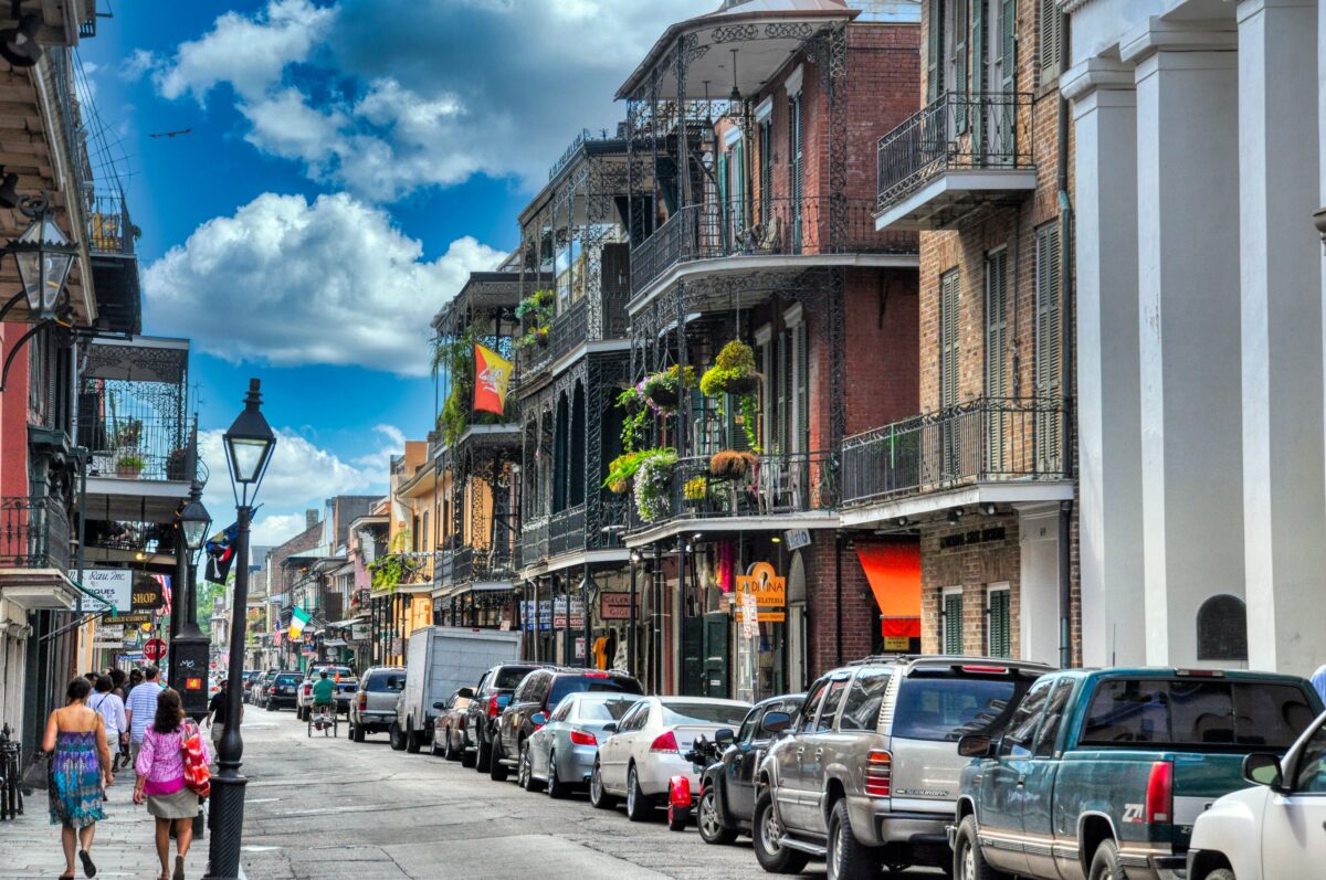 pexels 6379409 | Two Scots Abroad Vibrant day in New Orleans' French Quarter with people walking and historic architecture lining the street.