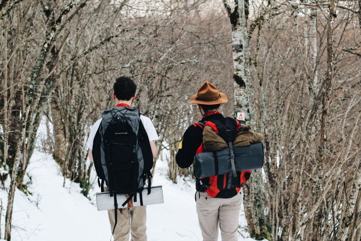 pexels 6395039 | Two Scots Abroad Two men hiking in a snow-covered forest, showcasing winter adventure and exploration.