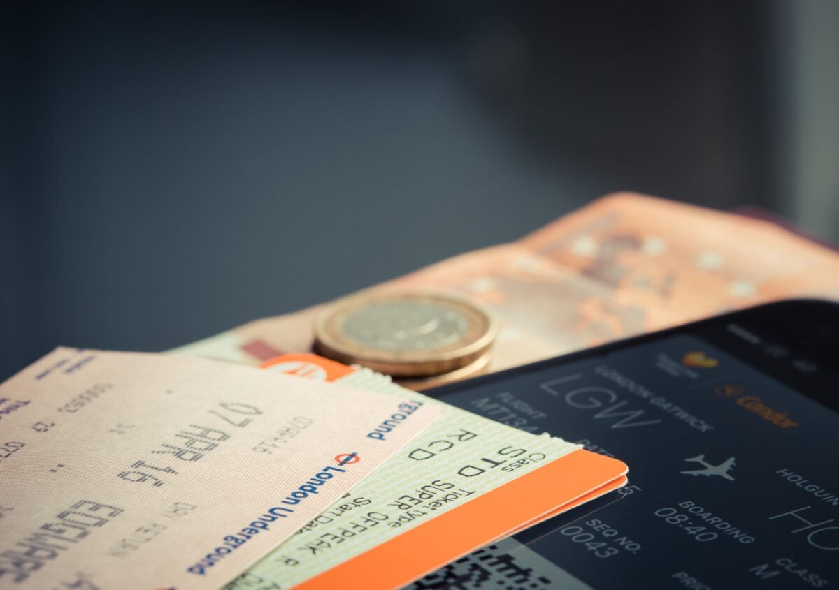 pexels 69866 | Two Scots Abroad Airline ticket with euro coins and smartphone displaying flight details.