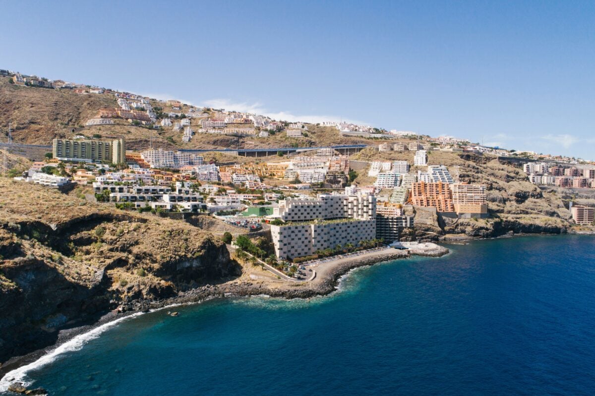 pexels 8356533 | Two Scots Abroad Stunning aerial view of Tenerife coastline with resorts and ocean under clear blue sky.