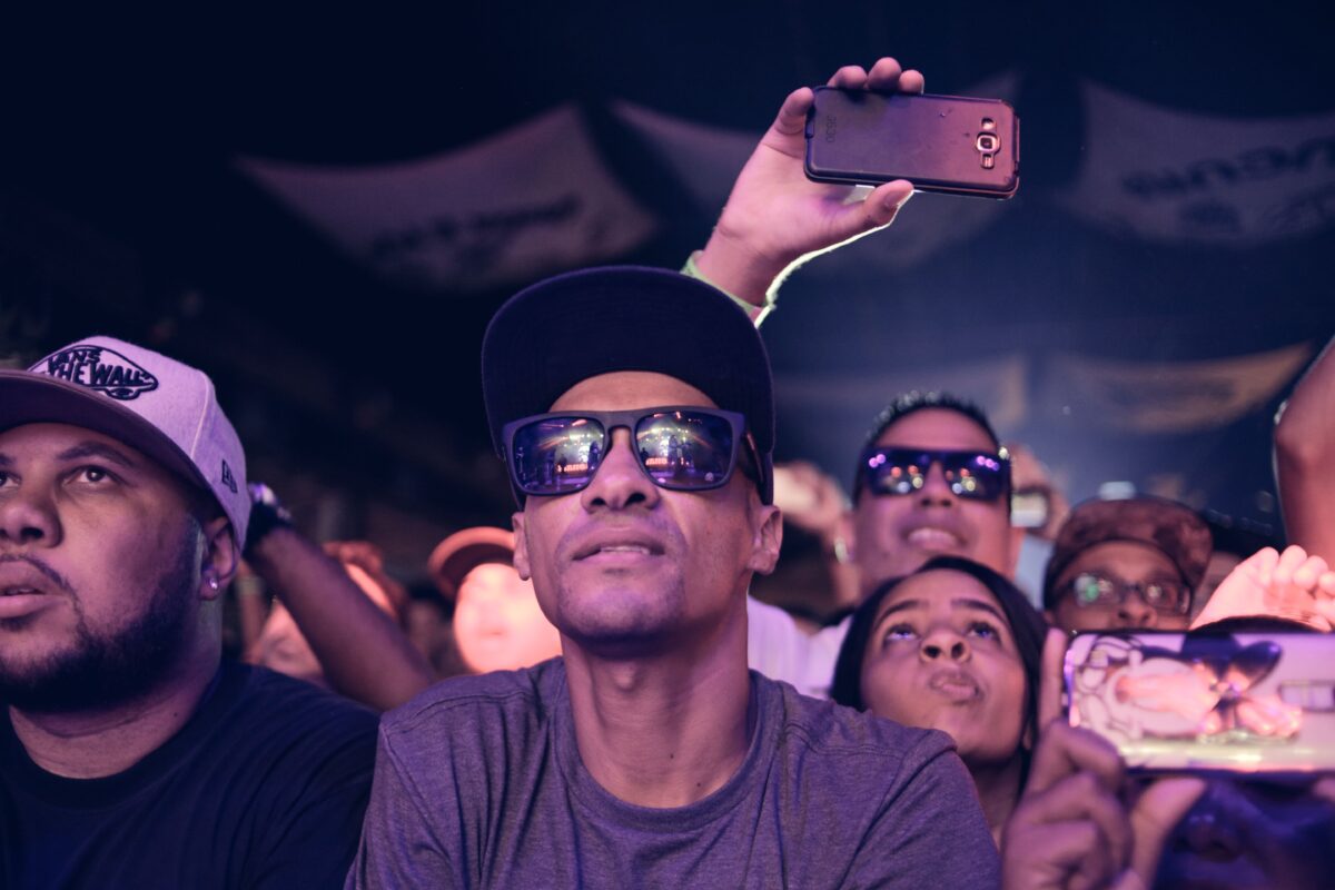 pexels 972376 | Two Scots Abroad Enthusiastic concert-goers capturing moments at a lively Brazilian music event.