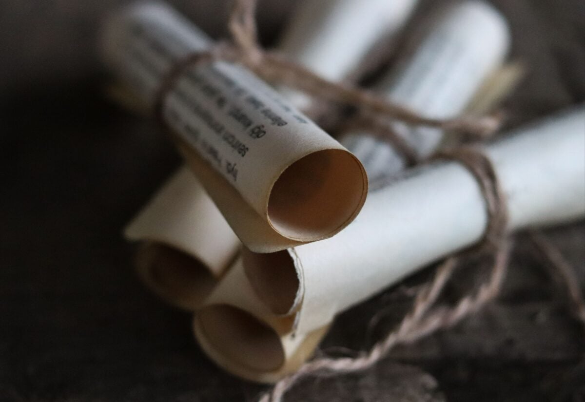 pexels 9801351 | Two Scots Abroad Close-up of vintage rolled paper scrolls tied with twine, perfect for historical themes.