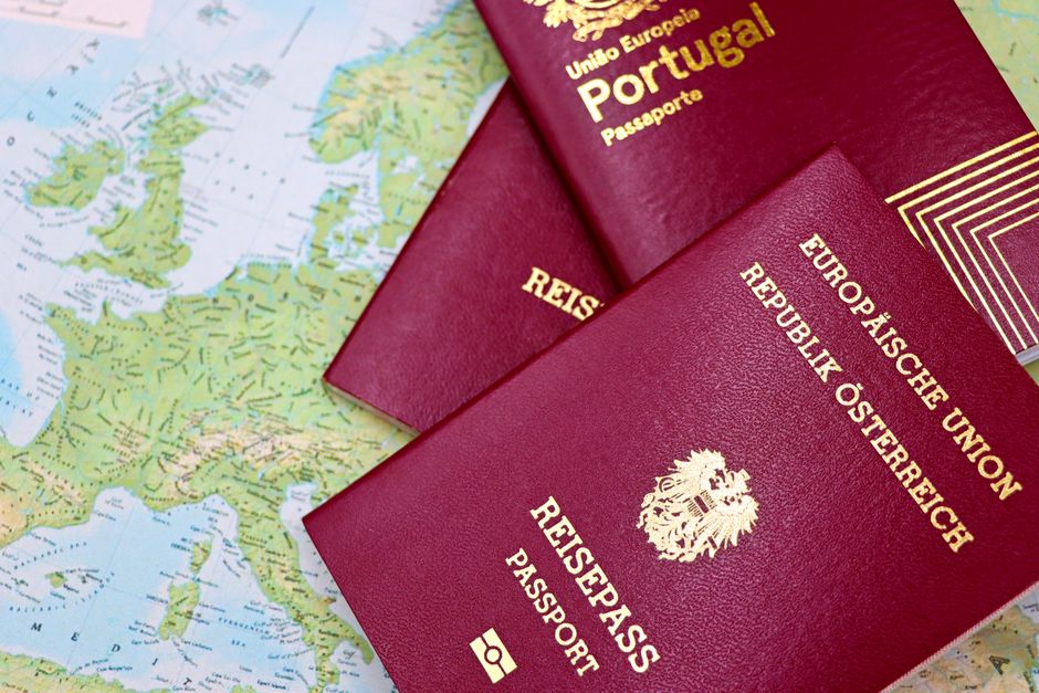 close up of european passports from portugal and austria on a world map | Two Scots Abroad Close-up of European passports from Portugal and Austria on a world map.