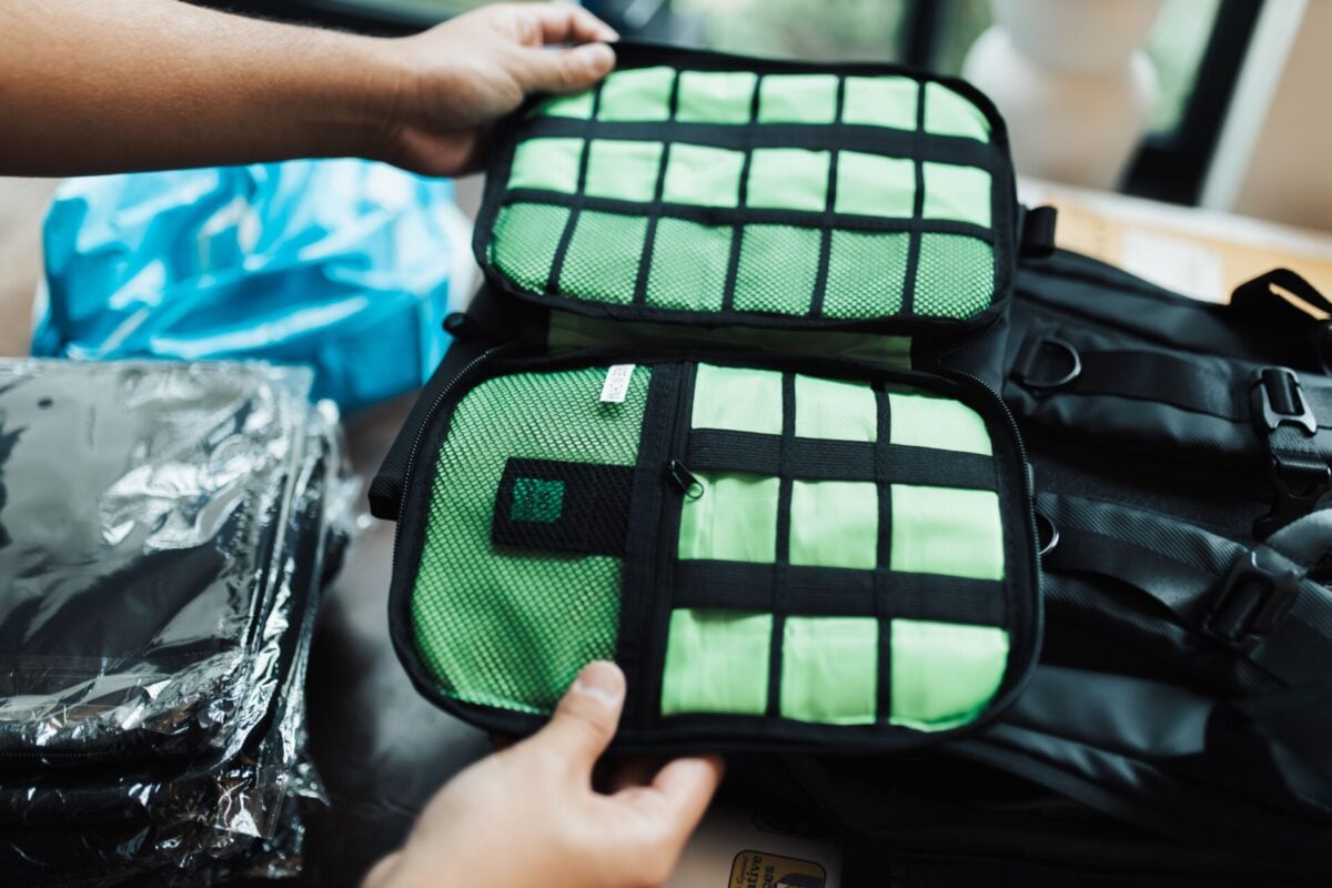 pexels 18999368 | Two Scots Abroad Close-up of hands organizing a travel luggage with packing cubes for efficient packing.
