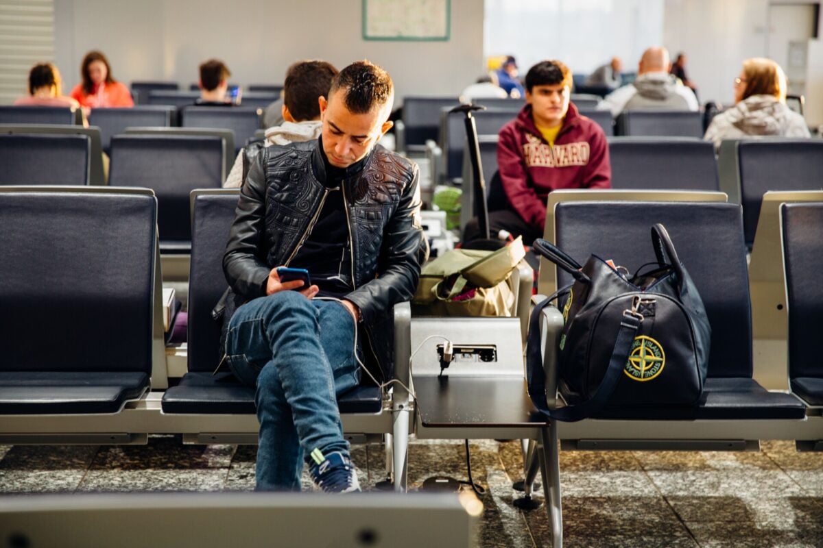 pexels 3750198 | Two Scots Abroad People sitting in an airport lounge, focused on smartphones and waiting for flights.