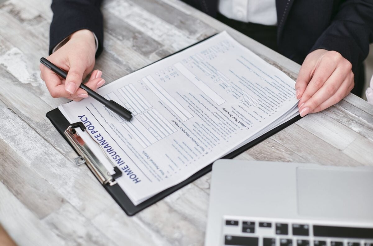 pexels 7734569 | Two Scots Abroad Close-up of hands reviewing a home insurance policy, emphasizing professionalism and finance.