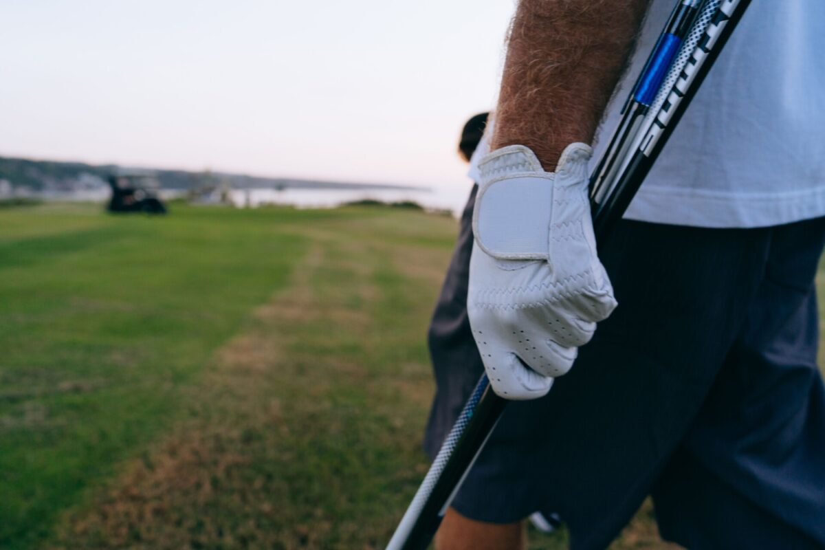 pexels 9207650 | Two Scots Abroad Close-up of a golfer's gloved hand holding a club on a beautiful golf course.