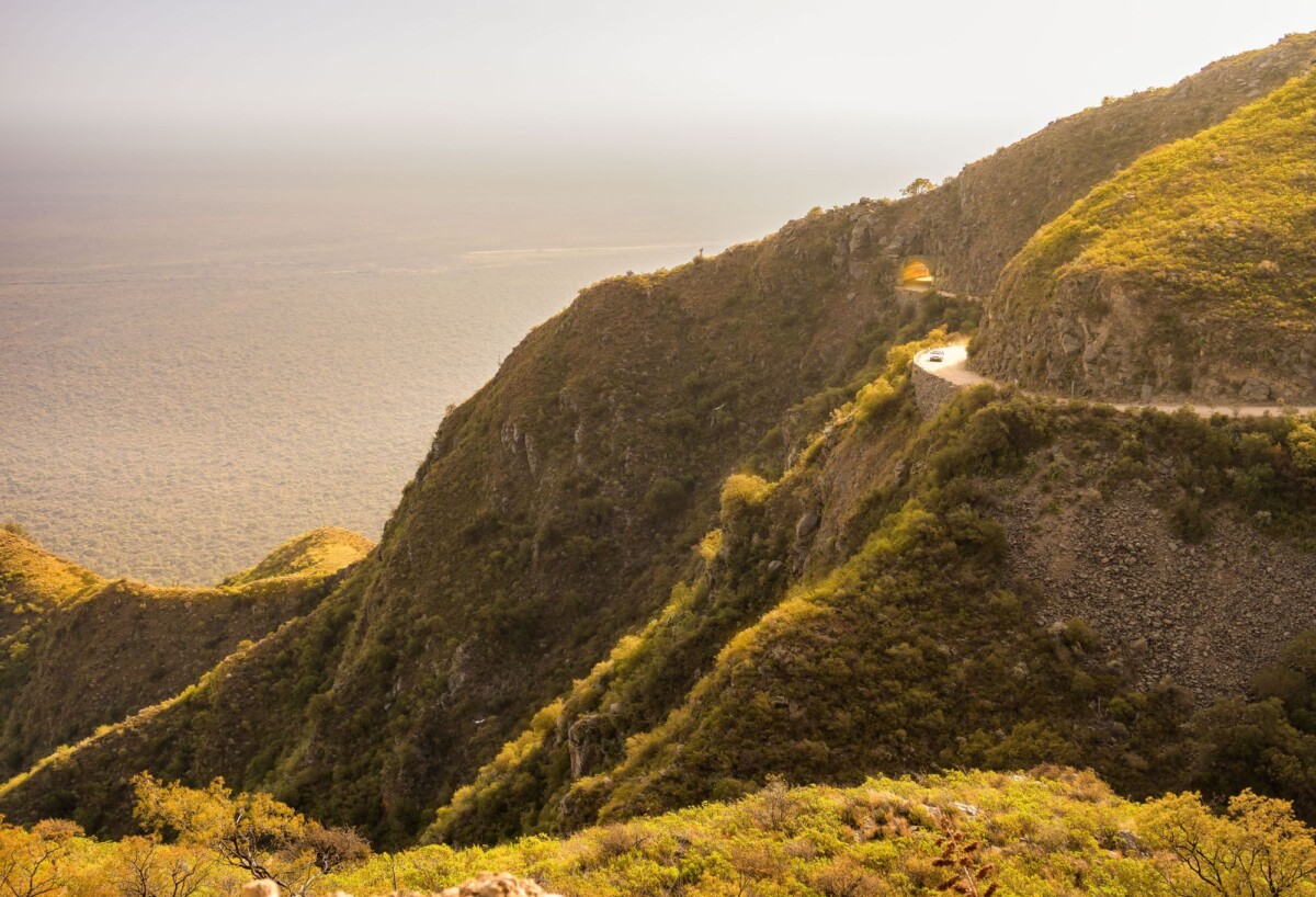 a breathtaking view of a winding road through the mountains in taninga cordoba a | Two Scots Abroad A breathtaking view of a winding road through the mountains in Taninga, Córdoba, Argentina.