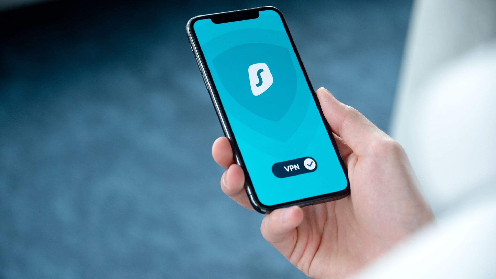 a hand holding a smartphone displaying a vpn app screen for secure online browsi | Two Scots Abroad A hand holding a smartphone displaying a VPN app screen for secure online browsing.
