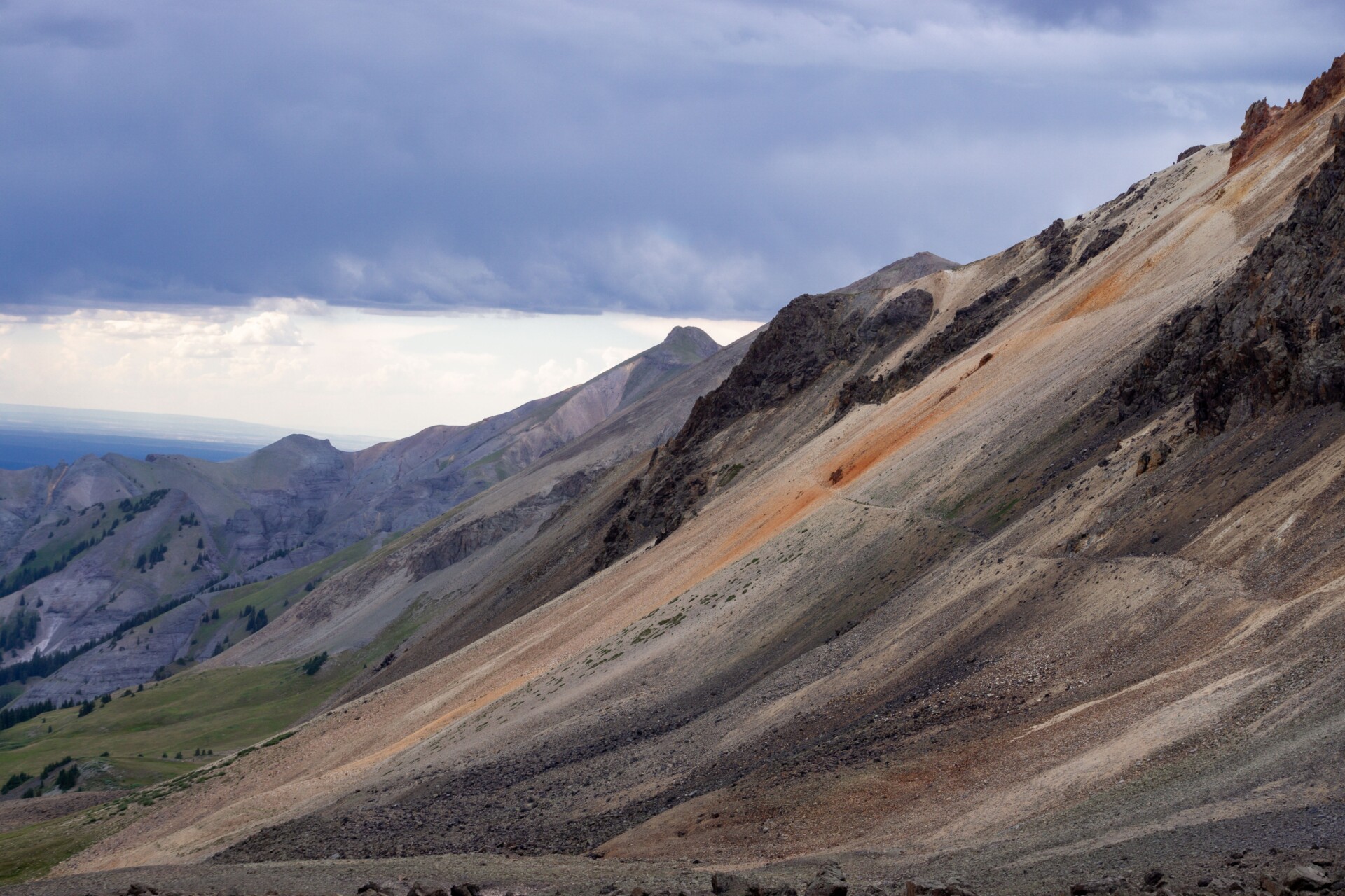 A rugged mountain landscape with ominous clouds in the Colorado Rockies.