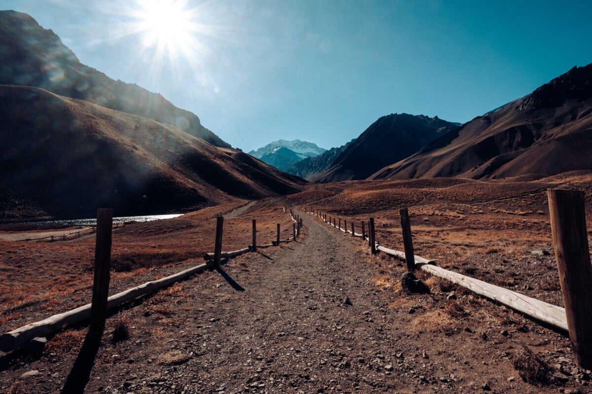 A stunning view of a mountain path under the bright sun in Mendoza Province, Argentina.