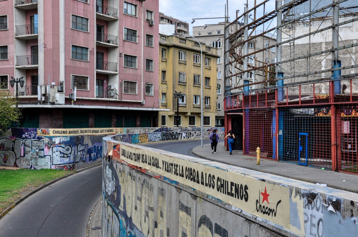 A vibrant urban street scene in Santiago, Chile showcasing graffiti art and architecture.