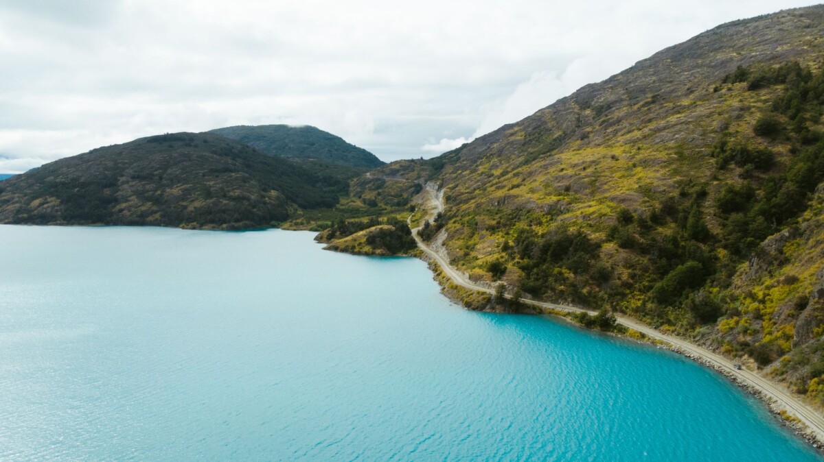 breathtaking aerial view of a serene lake and winding road in puerto montt chile | Two Scots Abroad Breathtaking aerial view of a serene lake and winding road in Puerto Montt, Chile.