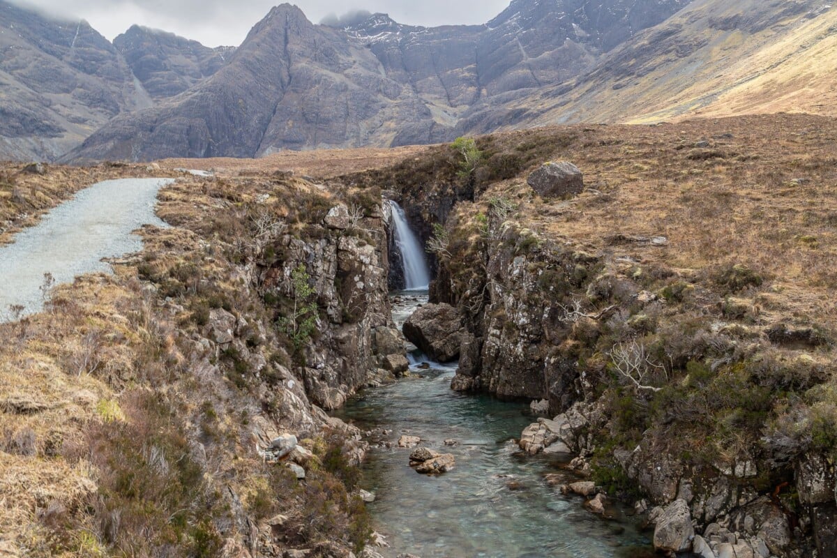 Breathtaking landscape of the Fairy Pools in Scotland, showcasing clear water and rugged mountains.
