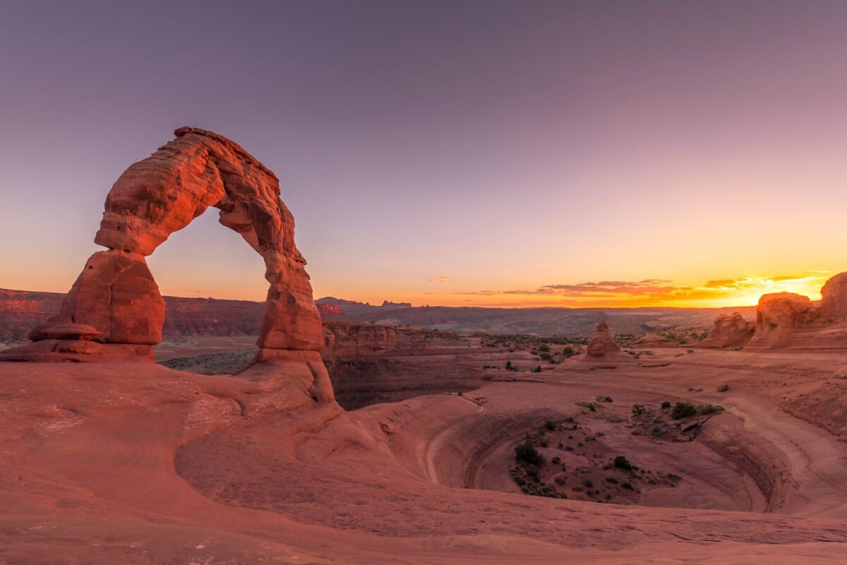 breathtaking view of delicate arch in arches national park at sunset showcasing | Two Scots Abroad Breathtaking view of Delicate Arch in Arches National Park at sunset, showcasing vibrant skies and rugged landscape.